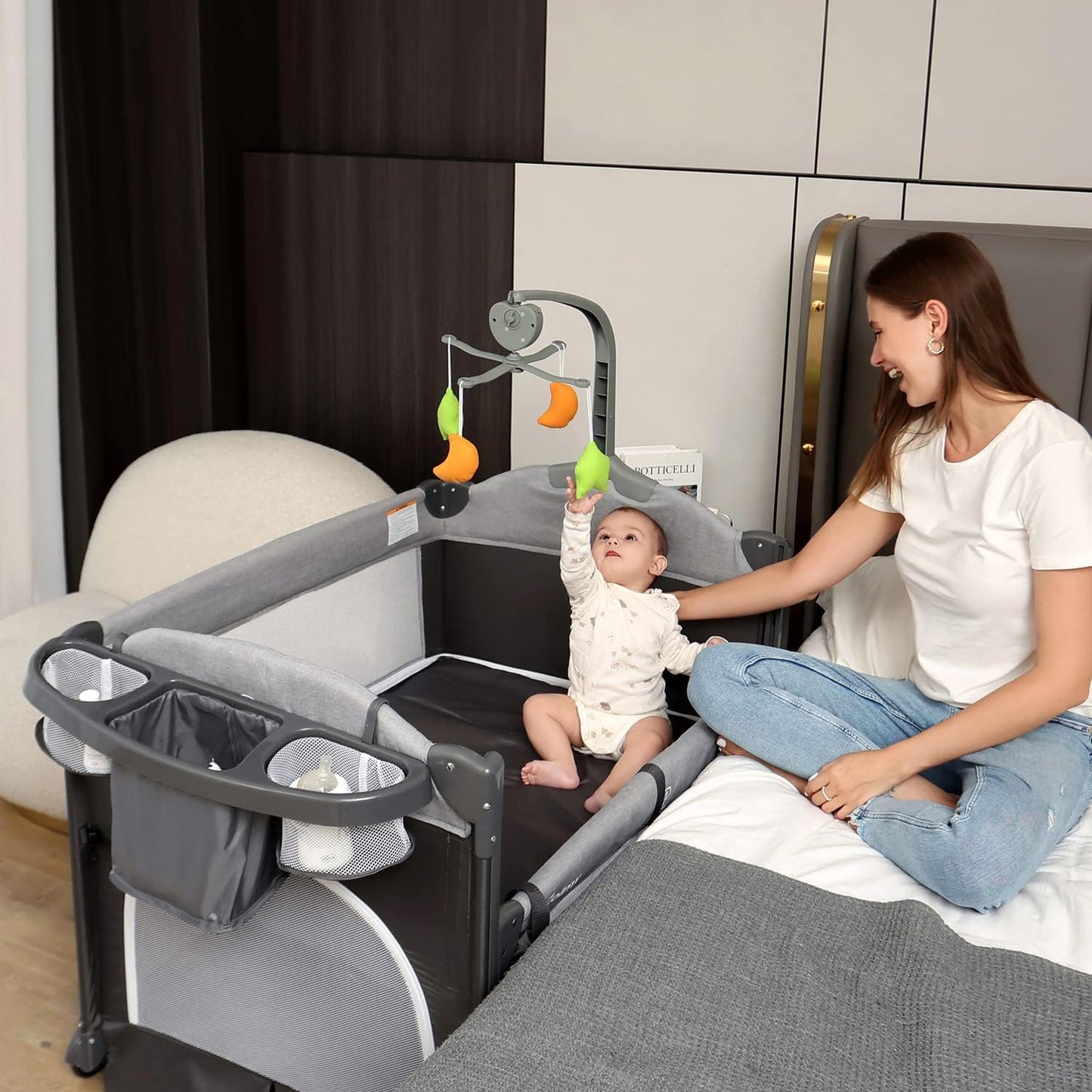 Zdolmy Baby Bedside Sleeper Bassinet, 4-in-1 Pack and Play with Bassinet w/Diaper Changing Table & Storage Bag, 3 Adjustable Heights, Toy Arch & Music, Portable Baby Play Yard with Carry Bag